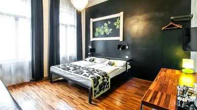 a small bedroom with a bed and a table at Czech Inn in Prague