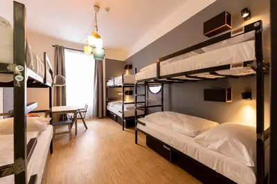 a bedroom with two bunk beds and a desk at Czech Inn in Prague