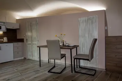 a kitchen with a table and chairs in a room at Apartmán U Gotického dvojčete in Litoměřice