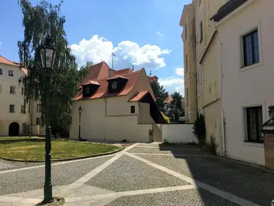 a street with a building with a red roof at Apartmán U Gotického dvojčete in Litoměřice