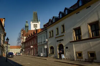 a city street with a clock tower in the background at Apartmán U Gotického dvojčete in Litoměřice