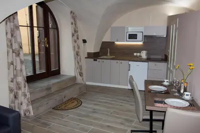 a small kitchen with a table and a counter top at Apartmán U Gotického dvojčete in Litoměřice