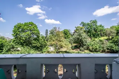 a view from a bridge with trees in the background at Garden Apartments in Prague