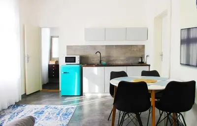 a kitchen with a table and chairs and a blue refrigerator at Václavkova Apartment in Mladá Boleslav