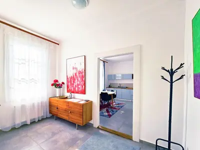 a room with a wooden dresser and a room with a table at Václavkova Apartment in Mladá Boleslav