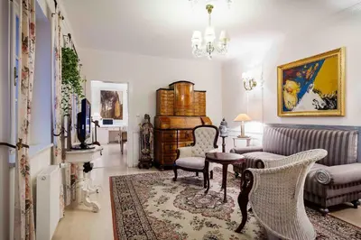 a living room with a couch and a table and chairs at Nebozizek Hotel a Restaurant in Prague