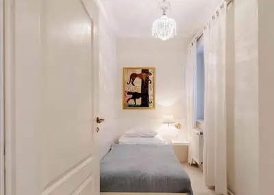 a bedroom with a bed and a chandelier at Nebozizek Hotel a Restaurant in Prague