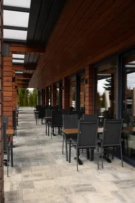 a row of tables and chairs on a patio at GAZDA Hotel&Restaurant - Self Chek-In in Jesenice