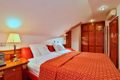 a bedroom with a large bed with a red blanket at U Páva in Prague