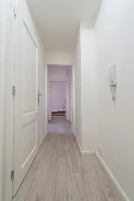 an empty hallway with a white door and a room at Quiet apartment in the city center with own terrace in Prague