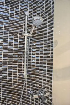 a shower with a shower head in a bathroom at Quiet apartment in the city center with own terrace in Prague
