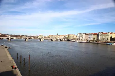a bridge over a river in a city with buildings at Quiet apartment in the city center with own terrace in Prague