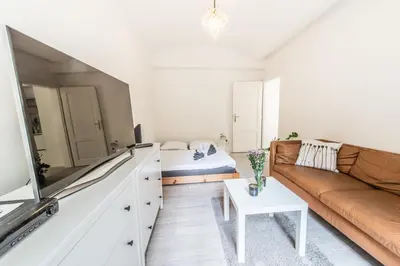 a living room with a couch and a bed at Quiet apartment in the city center with own terrace in Prague