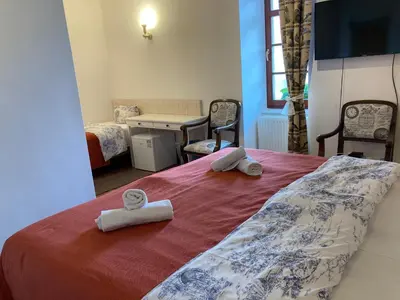 a bedroom with a bed with two towels on it at Penzion u Svatého Prokopa in Středokluky