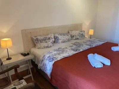 a bedroom with a bed with blue sheets and pillows at Penzion u Svatého Prokopa in Středokluky