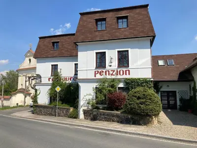 a white building with a sign that reads pentaxion at Penzion u Svatého Prokopa in Středokluky