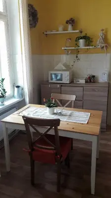 a table in a kitchen with a table and a chair at Apartmán pod rozhlednou in Roudnice nad Labem