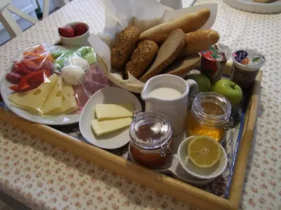 a tray of food with cheese and other foods on a table at Apartmán pod rozhlednou in Roudnice nad Labem