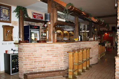 a bar in a restaurant with a brick wall at Hotel Bouček in Mochov
