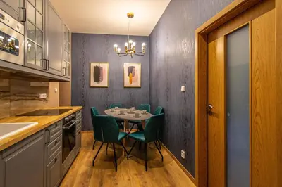 a dining room with a table and green chairs at Ruterra Apartments by Cathedral in Prague