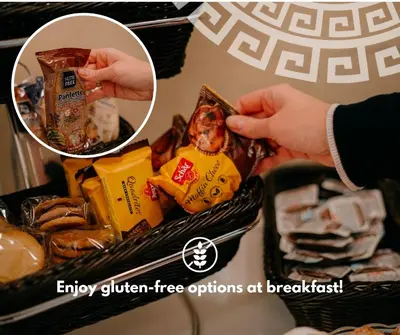 a person holding up food in a basket of food at Hotel Galatea in Mladá Boleslav