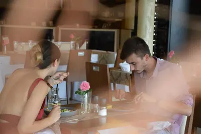 a man and a woman sitting at a table eating food at Hotel Galatea in Mladá Boleslav