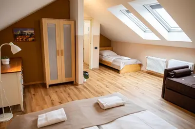 a room with a bed and a bedroom with skylights at Central 3bdr penthouse with terrace&AC in Prague