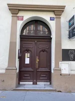 a large wooden door on a building at Central 3bdr penthouse with terrace&AC in Prague