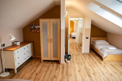 a attic bedroom with a bed and a closet at Central 3bdr penthouse with terrace&AC in Prague