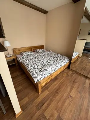 a bedroom with a bed and a wooden floor at Hip Prague Area Central Flat in Prague