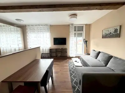 a living room with a couch and a table at Hip Prague Area Central Flat in Prague