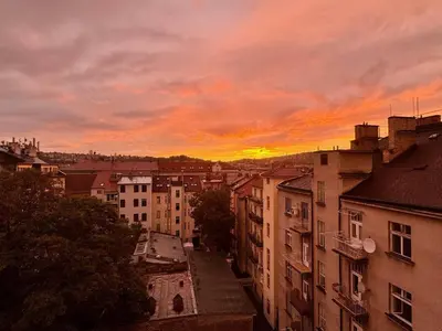a view of a city at sunset with buildings at Hip Prague Area Central Flat in Prague