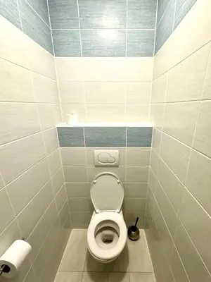 a bathroom with a white toilet in a stall at Hip Prague Area Central Flat in Prague
