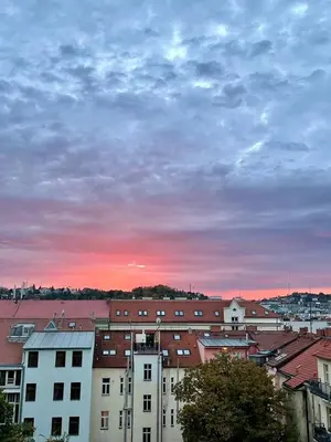 a city skyline with buildings and a cloudy sky at Hip Prague Area Central Flat in Prague