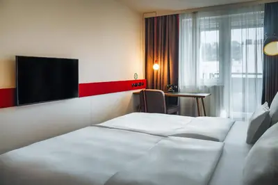a hotel room with a bed and a flat screen tv at Hotel PULSE8 in Prague