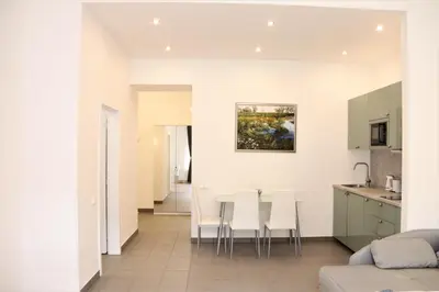 a kitchen and living room with a table and chairs at Flowers apartments in Prague