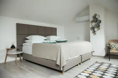 a bedroom with a large bed with white sheets and pillows at HONEST Smichov in Prague