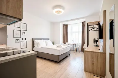 a living room with a bed and a kitchen at HONEST Smichov in Prague