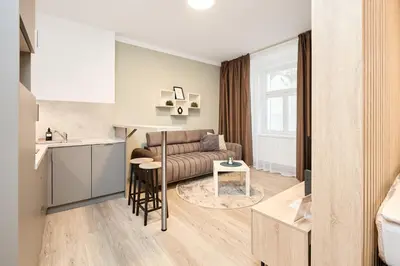 a living room with a couch and a table at HONEST Smichov in Prague