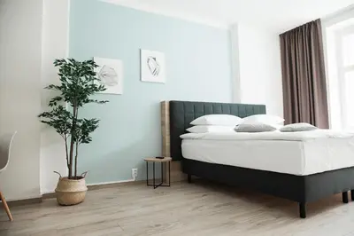 a bedroom with a bed and a potted plant at HONEST Smichov in Prague