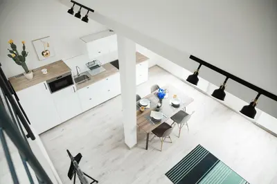 a kitchen and dining room with a table and chairs at HONEST Smichov in Prague