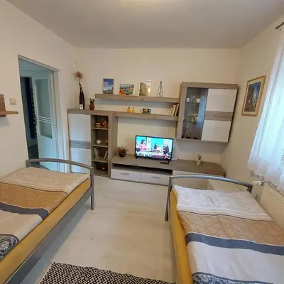 a room with two bunk beds and a television at Garsonka in Jílové u Prahy