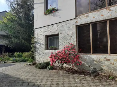 a brick house with flowers on the side of it at Garsonka in Jílové u Prahy