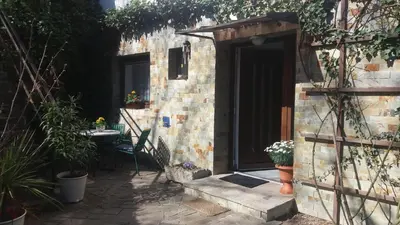 a small brick building with a door and a table at Garsonka in Jílové u Prahy