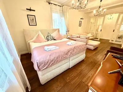 a bedroom with a large bed and a couch at Unique Charles Bridge 2BDR Apartment. in Prague