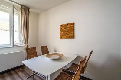 a dining room with a white table and chairs at Unique Charles Bridge 2BDR Apartment. in Prague