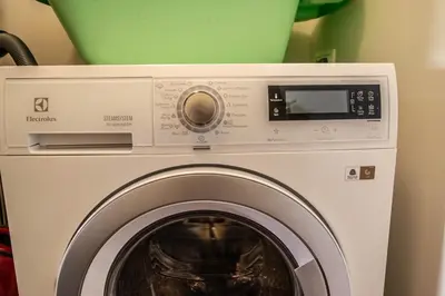 a washing machine with a washer in a room at Unique Charles Bridge 2BDR Apartment. in Prague