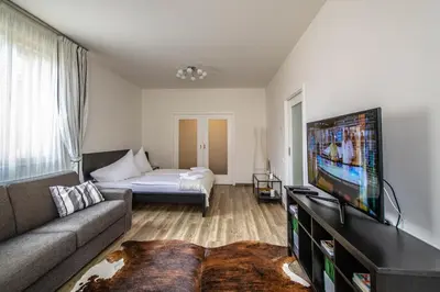 a living room with a couch and a flat screen tv at Unique Charles Bridge 2BDR Apartment. in Prague