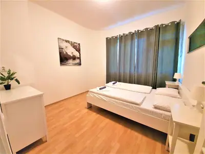 a bedroom with a bed and a desk in it at Epstein Apartments in Prague