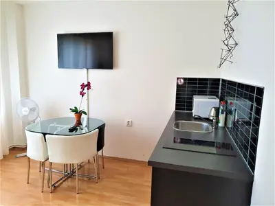 a kitchen with a glass table and a sink at Epstein Apartments in Prague